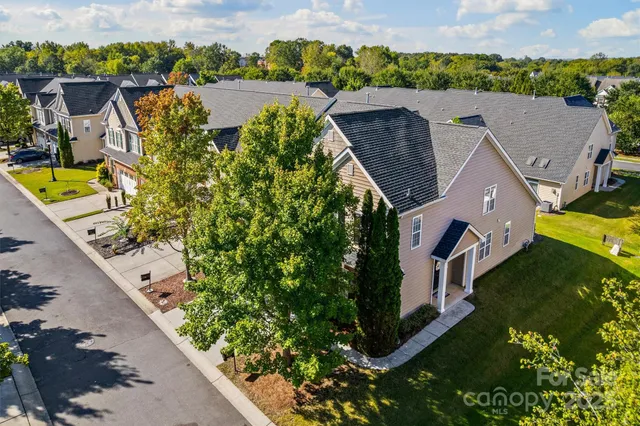 an aerial view of house with yard swimming pool and outdoor seating