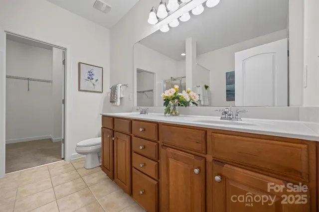 a spacious bathroom with a double vanity sink mirror and toilet