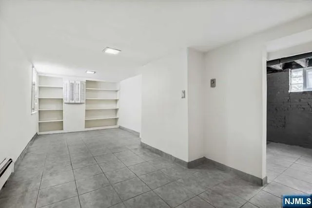 a view of a room with a cabinet and a refrigerator