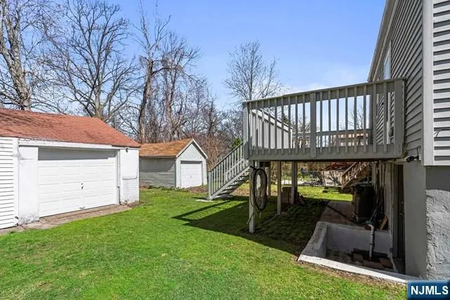 a view of backyard with a garden and deck