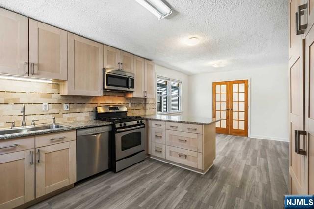122 Spring Street Leonia, NJ 07605 - Photo 9 of 19 a kitchen with granite countertop a stove top oven sink and cabinets