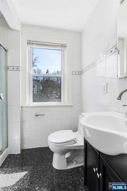 122 Spring Street Leonia, NJ 07605 - Photo 10 of 19 a bathroom with a sink toilet and shower