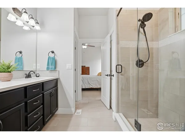 a en suite bathroom with a double vanity sink mirror and shower