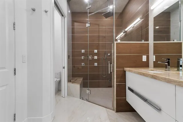a bathroom with a shower and a sink