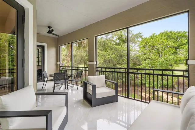 a balcony with furniture and a potted plant