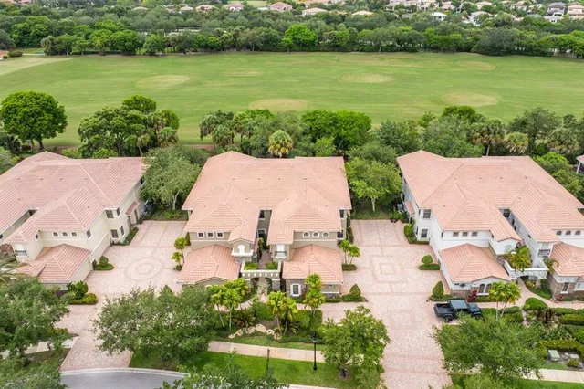 an aerial view of a house with a garden and lake view