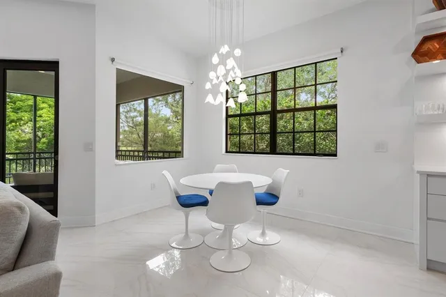 a dining room with furniture and window