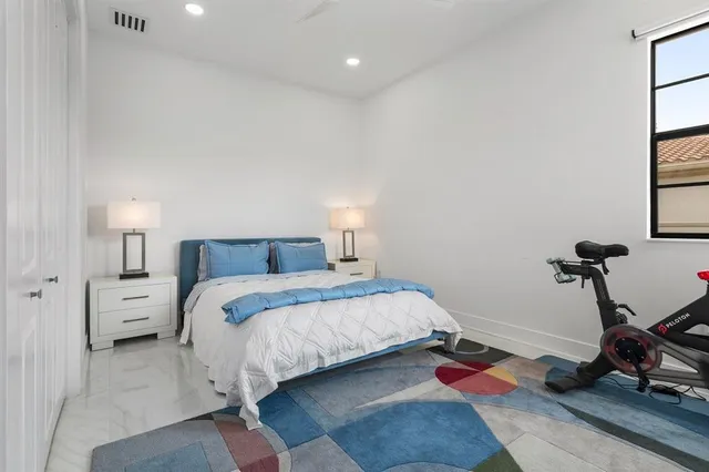 a bedroom with bed and a window