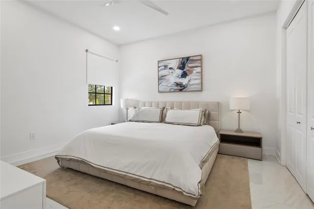 a bedroom with a bed and a painting