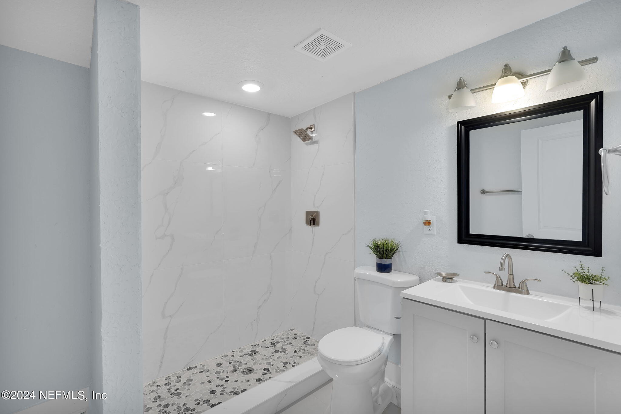 6763 Ector Road Jacksonville, FL 32211 - Photo 12 of 28 a bathroom with a sink toilet and shower