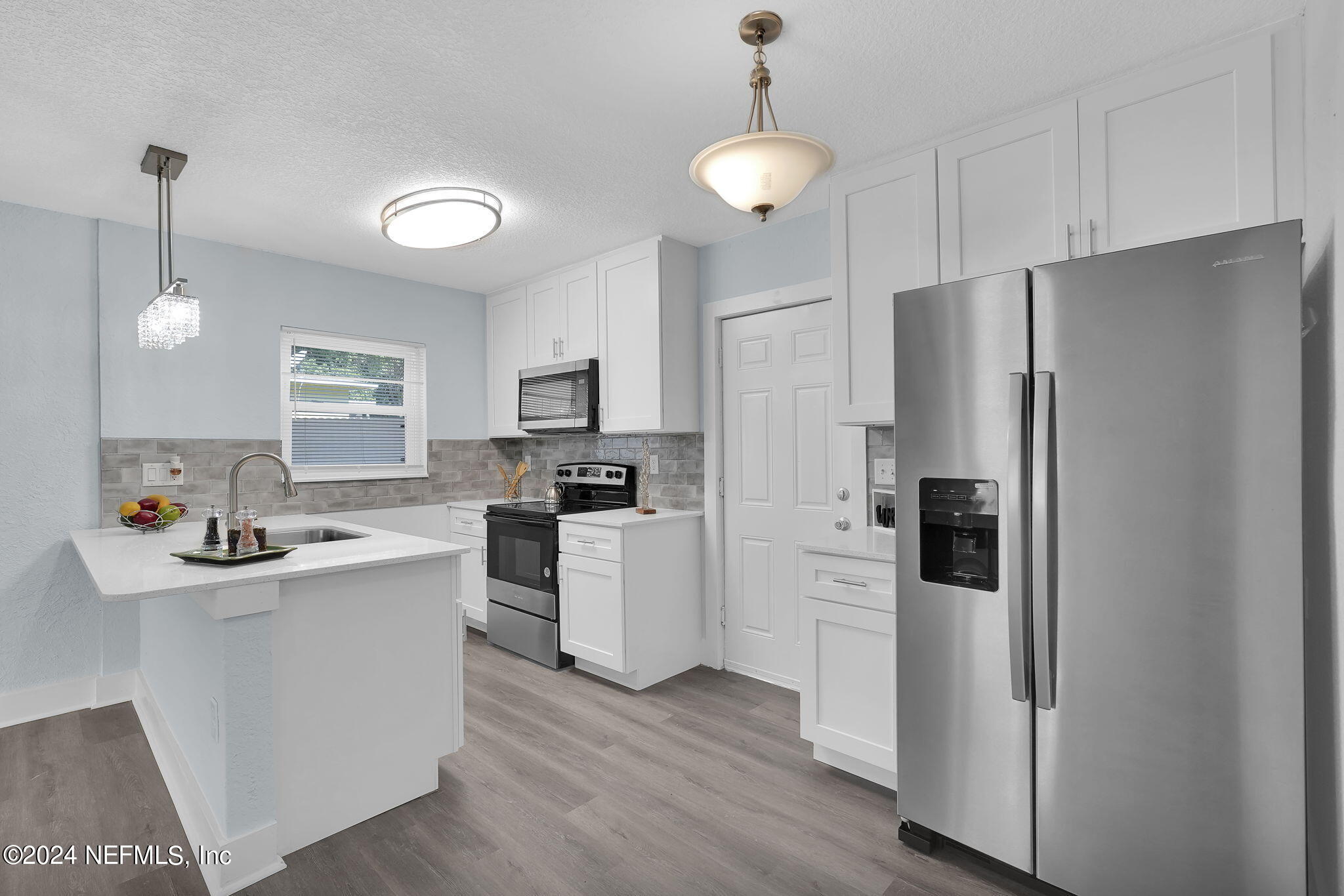 6763 Ector Road Jacksonville, FL 32211 - Photo 15 of 28 a kitchen with white cabinets and stainless steel appliances