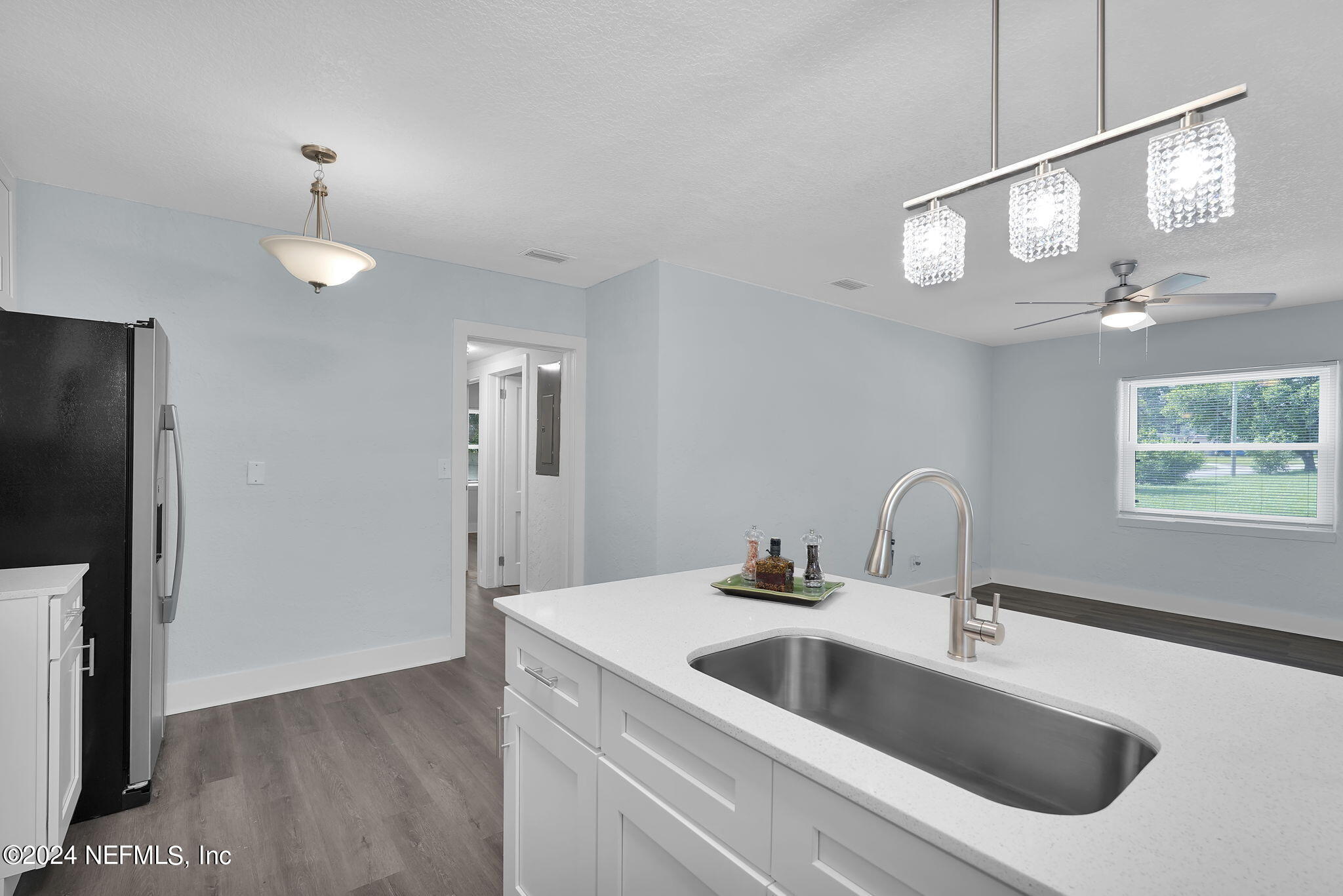 6763 Ector Road Jacksonville, FL 32211 - Photo 17 of 28 a kitchen with a sink and chandelier