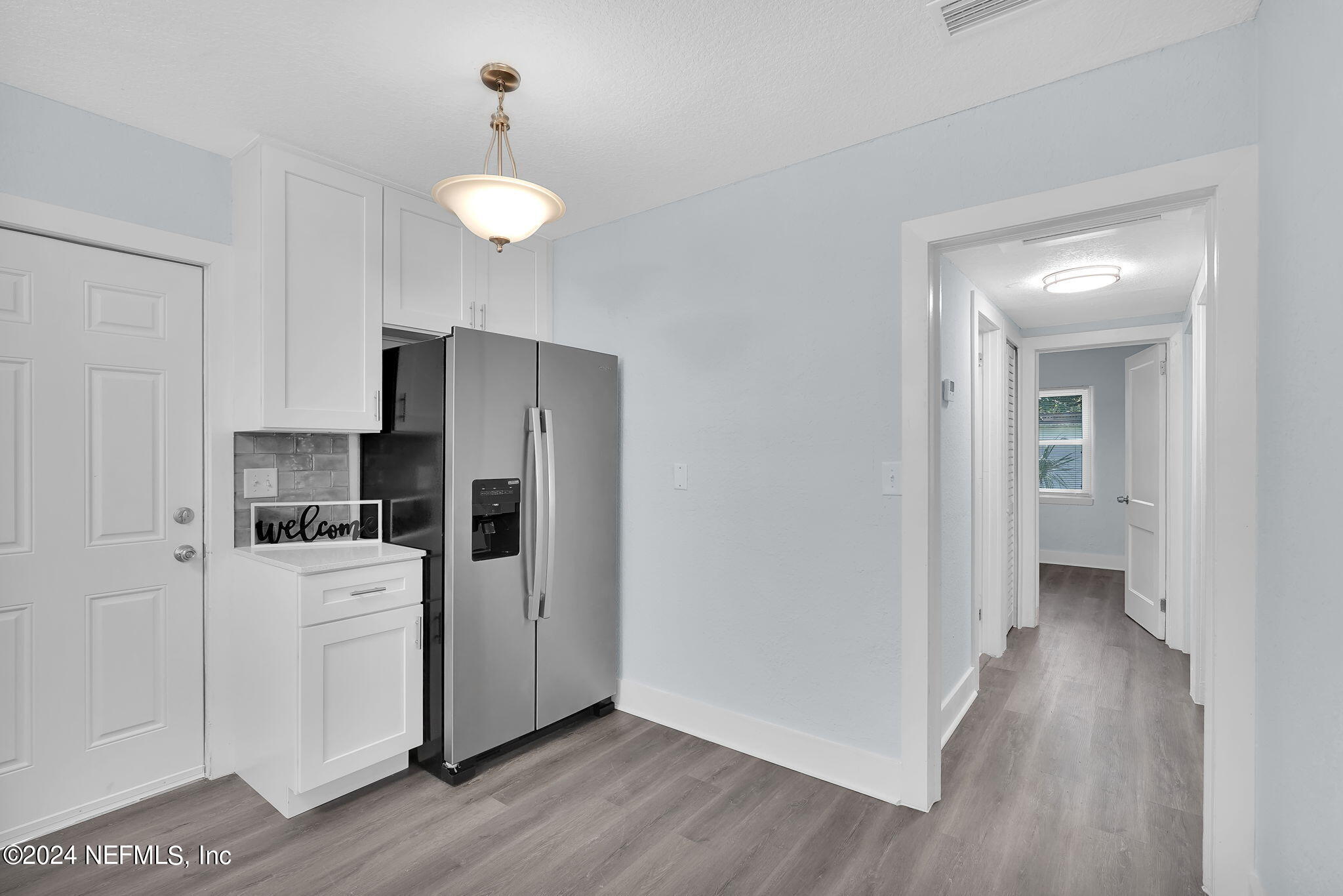 6763 Ector Road Jacksonville, FL 32211 - Photo 18 of 28 a kitchen with a refrigerator and a stove top oven