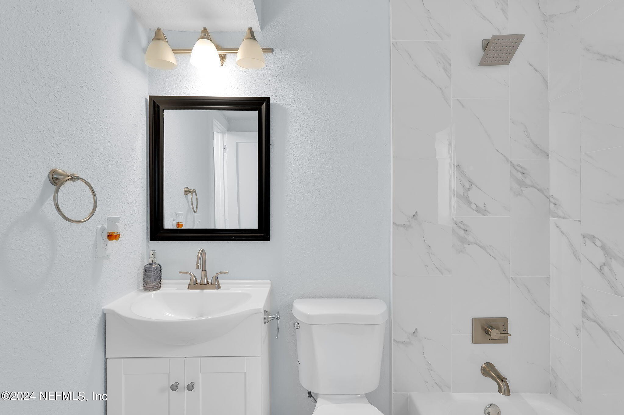 6763 Ector Road Jacksonville, FL 32211 - Photo 20 of 28 a bathroom with a toilet sink vanity and mirror