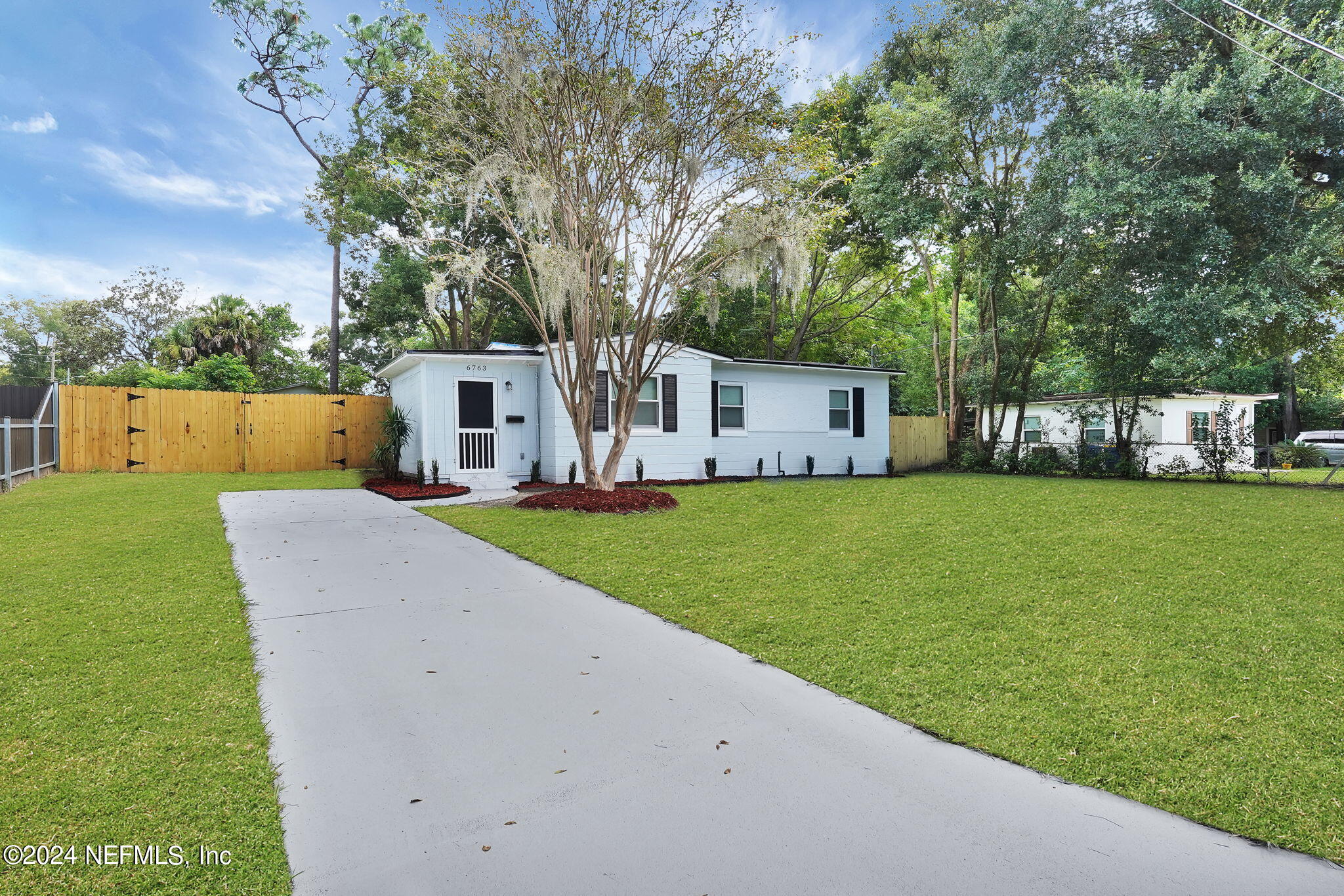 6763 Ector Road Jacksonville, FL 32211 - Photo 4 of 28 a view of house with a big yard potted plants and large tree