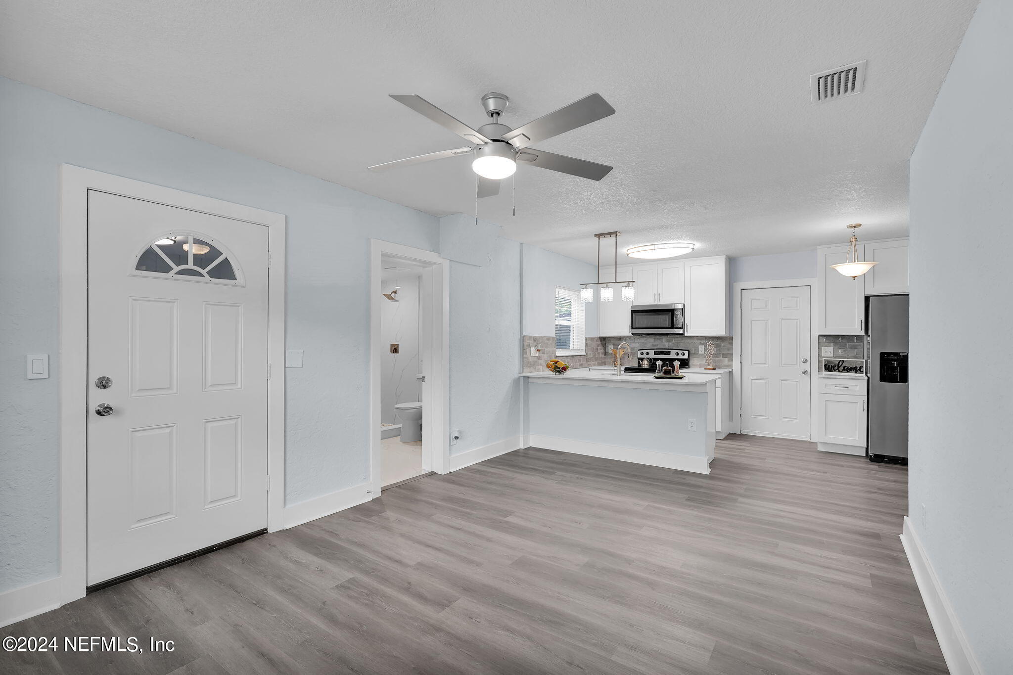 6763 Ector Road Jacksonville, FL 32211 - Photo 8 of 28 a view of kitchen with wooden floor and window