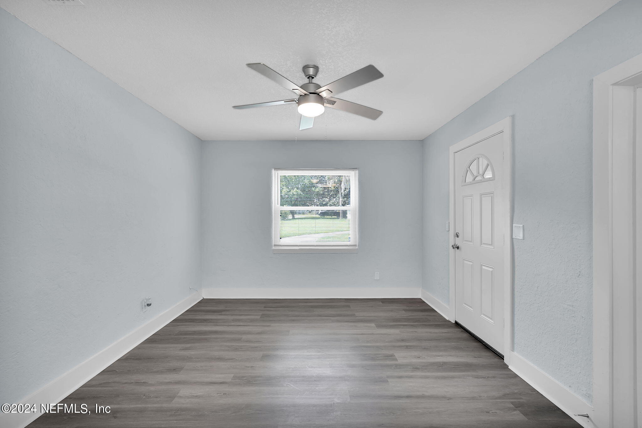 6763 Ector Road Jacksonville, FL 32211 - Photo 10 of 28 a view of an empty room with window and wooden floor