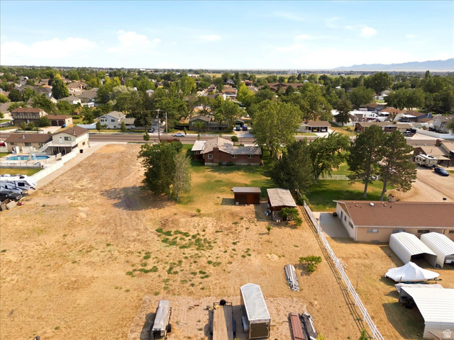 2252 West 800 North Clinton, UT 84015 - Photo 35 of 38 Expansive lot featuring a large, undeveloped parcel with partial fencing and established trees