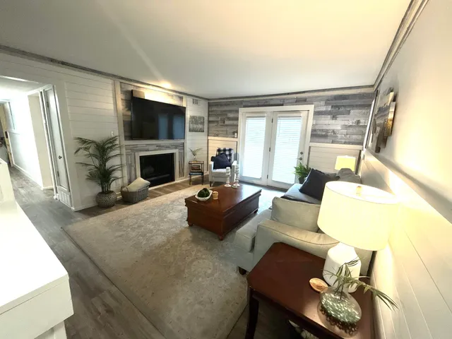 a living room with furniture fireplace and a flat screen tv