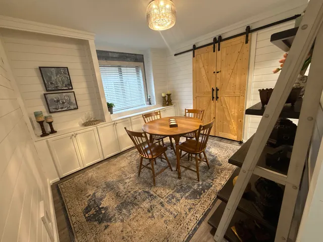 a dining room with furniture and window
