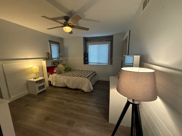 a bedroom with a bed and a lamp with window