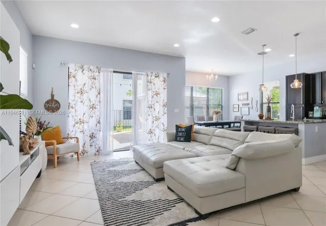 a living room with furniture and a large window