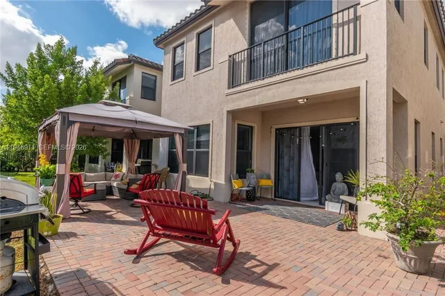 a view of a house with a porch and sitting area