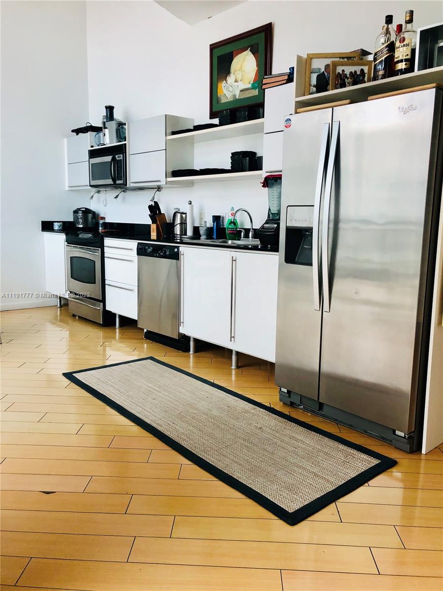 690 Southwest 1st Court, Unit 2926 Miami, FL 33130 - Photo 14 of 26 a kitchen with stainless steel appliances granite countertop a refrigerator and a stove