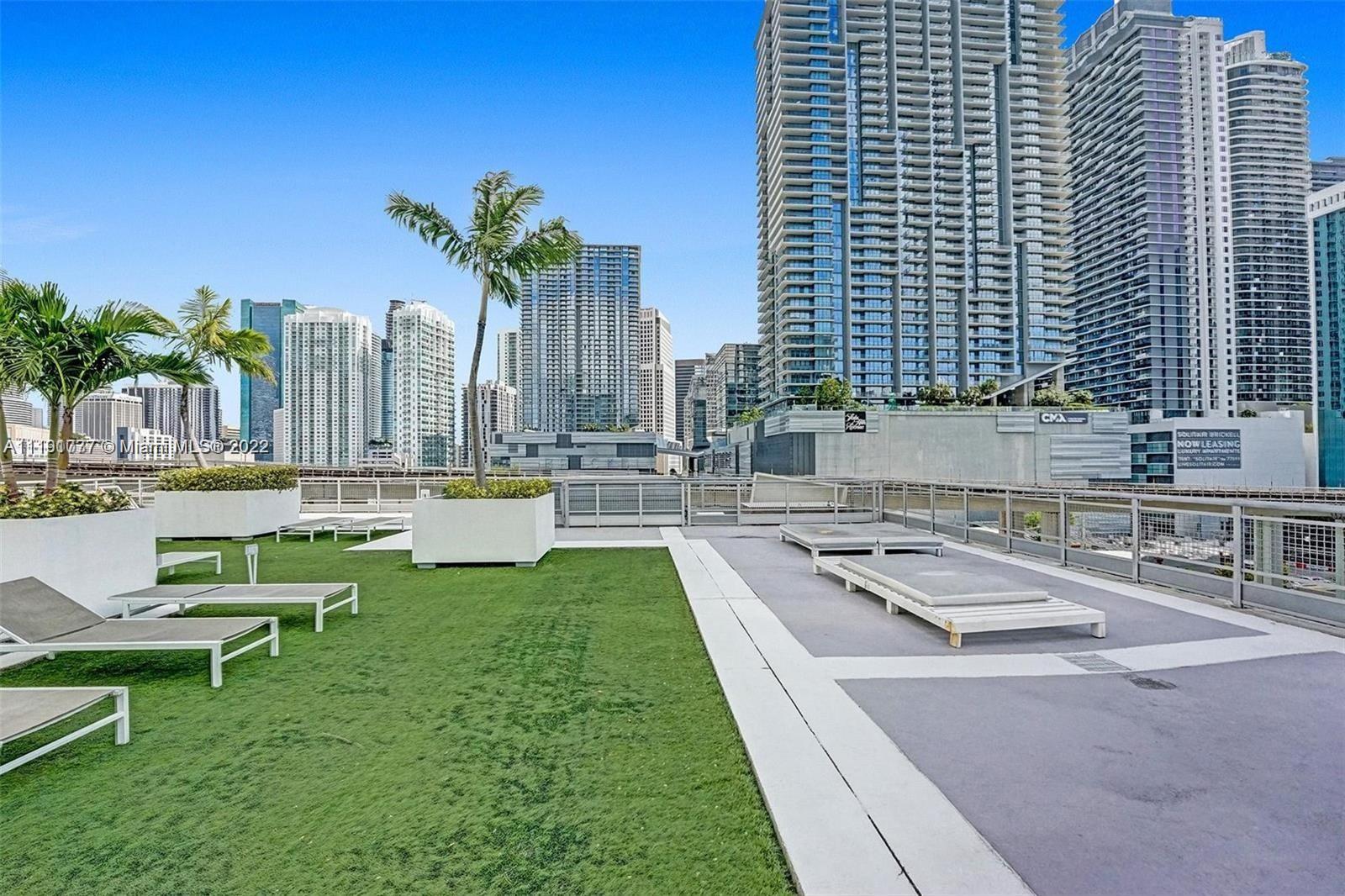 690 Southwest 1st Court, Unit 2926 Miami, FL 33130 - Photo 26 of 26 a swimming pool with outdoor seating and yard