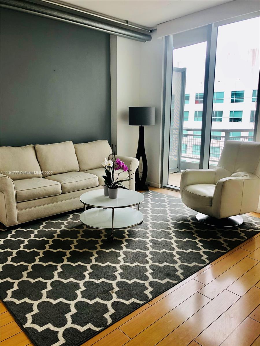 690 Southwest 1st Court, Unit 2926 Miami, FL 33130 - Photo 9 of 26 a living room with furniture and a rug