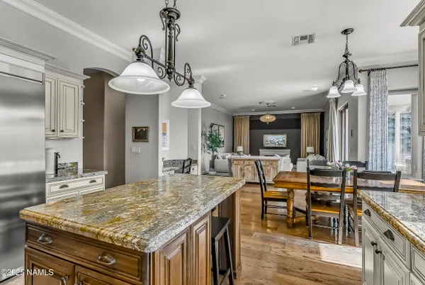 a kitchen with stainless steel appliances granite countertop a kitchen island a stove and a sink