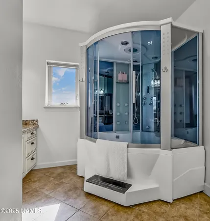 a bedroom with a bed table and a potted plant