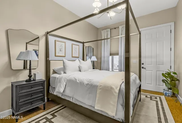 a bedroom with a bed and a painting on the wall