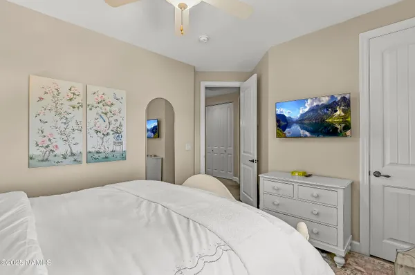 a bedroom with a bed and a desk