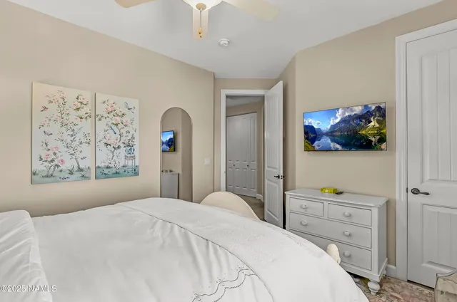 a bedroom with a bed and a desk