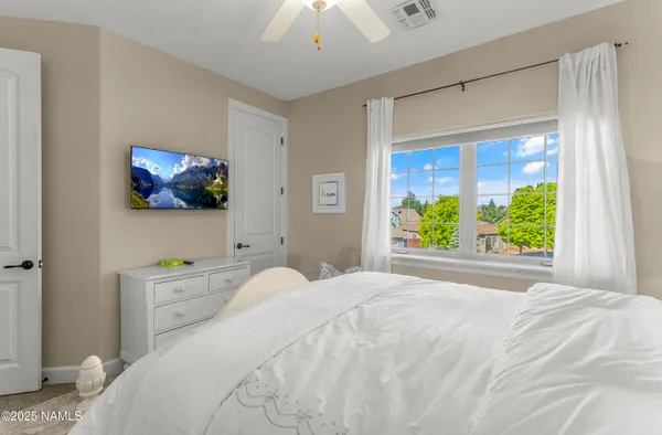 a bed room with a bed and a chandelier