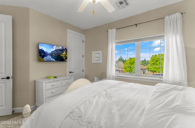 a bed room with a bed and a chandelier