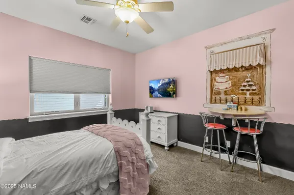 a bedroom with a bed and a table in it