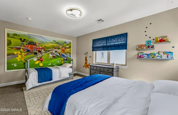 a bedroom with a bed dresser and a window