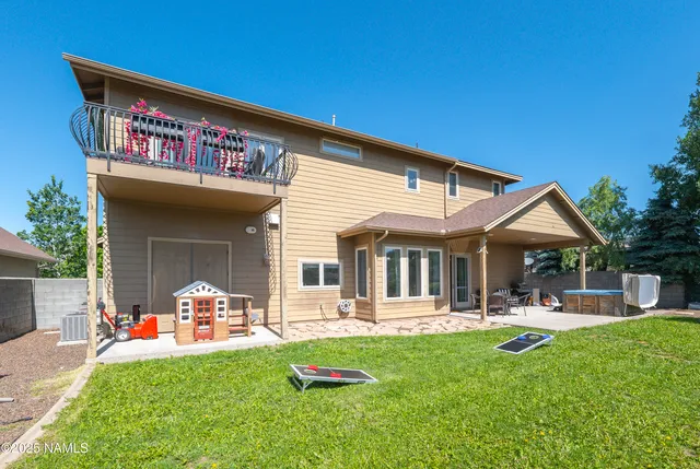 a view of a house with backyard porch and sitting area