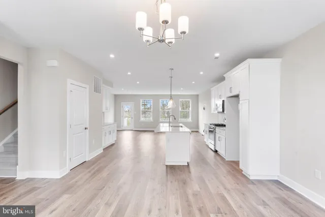 a view of a kitchen with wooden floor and a chandelier