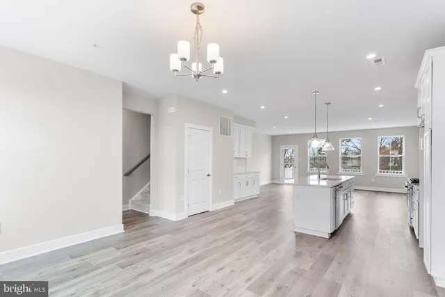 a view of a large kitchen with furniture and wooden floor