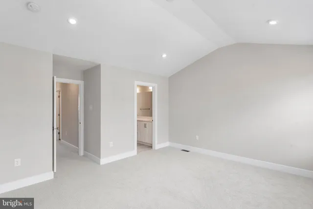 an empty room with closet and bathroom