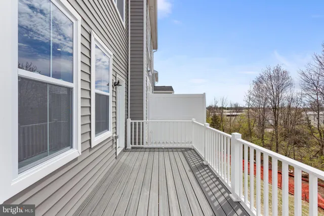a view of balcony with wooden floor and lake view
