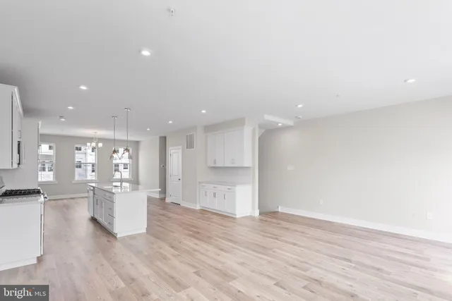 a view of kitchen with refrigerator and wooden floor