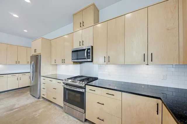 a kitchen with kitchen island a sink a counter and a large window