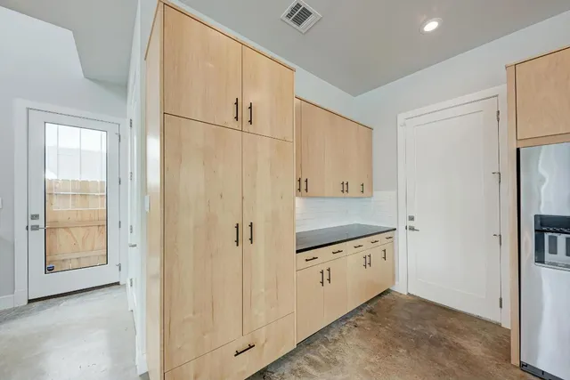 a kitchen with stainless steel appliances granite countertop a refrigerator sink and cabinets
