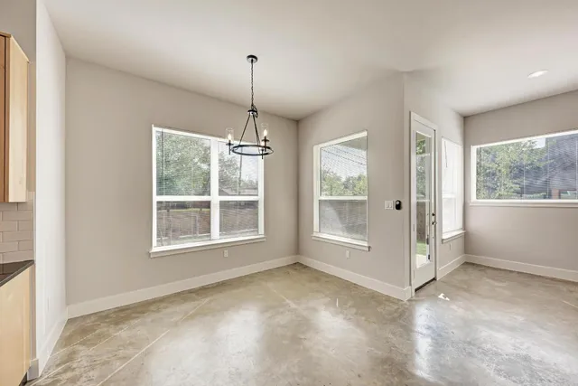 a view of a kitchen with white cabinets