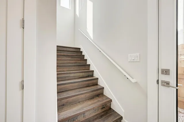a bathroom with a granite countertop toilet a sink and a mirror