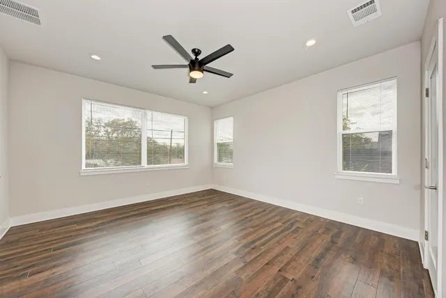 wooden floor in an empty room with a window